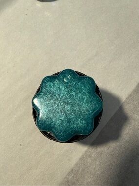 Blue-green or Teal Star-Shaped  “Pop Socket-like” Phone Grip